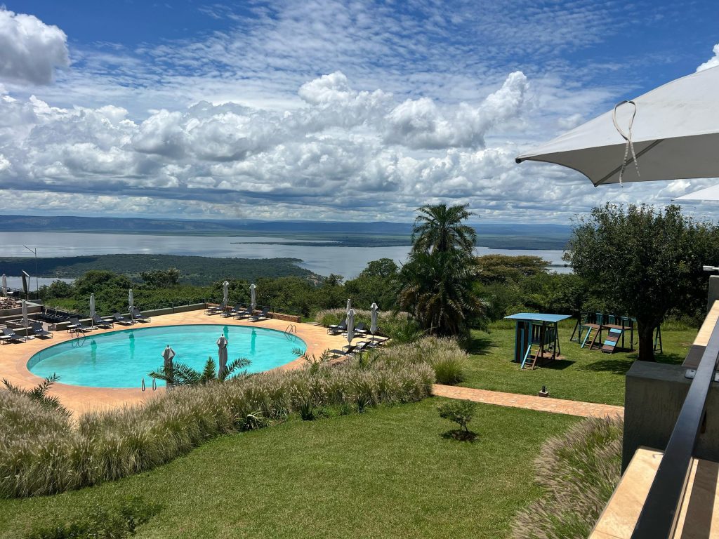Scenic view of the Mentis Akagera Game Lodge in Akagera National Park overlooking the lake and hills, photographed by Enock during golden hour.